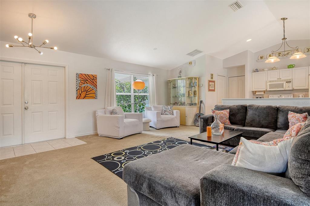 2276 Polaris Road North Port, FL 34291 - Photo 10 of 31 a living room with furniture and a chandelier