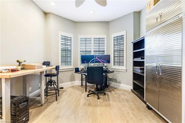 a view of a workspace with furniture and a window
