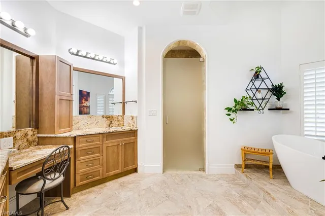 a spacious bathroom with a granite countertop sink and a mirror