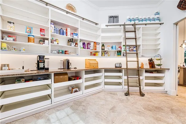 a view of kitchen with cabinets and window