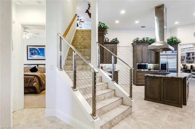 a living room with furniture a rug and a chandelier