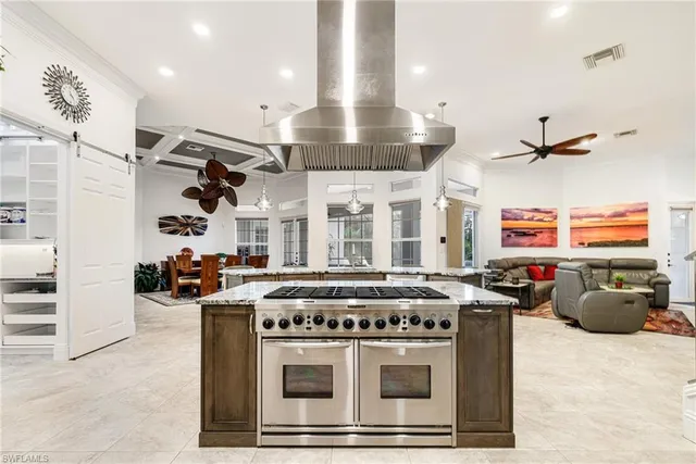 a kitchen with a stove and a chandelier
