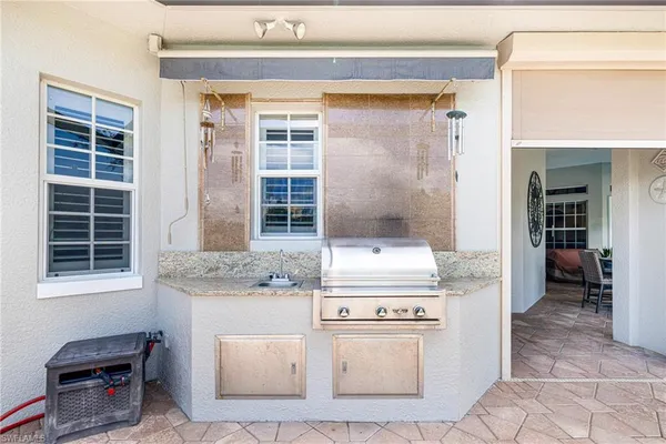 a swimming pool with outdoor seating yard and barbeque oven