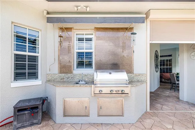 a swimming pool with outdoor seating yard and barbeque oven