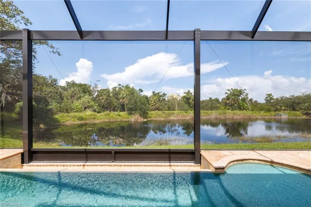 a front view of a house with a yard and an tree