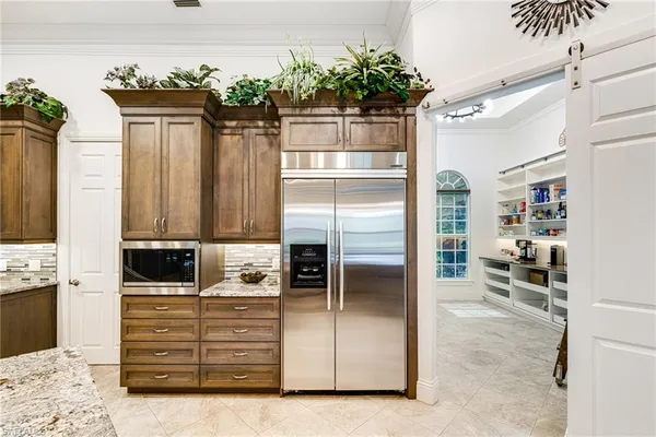 a kitchen with kitchen island a counter top space and cabinets