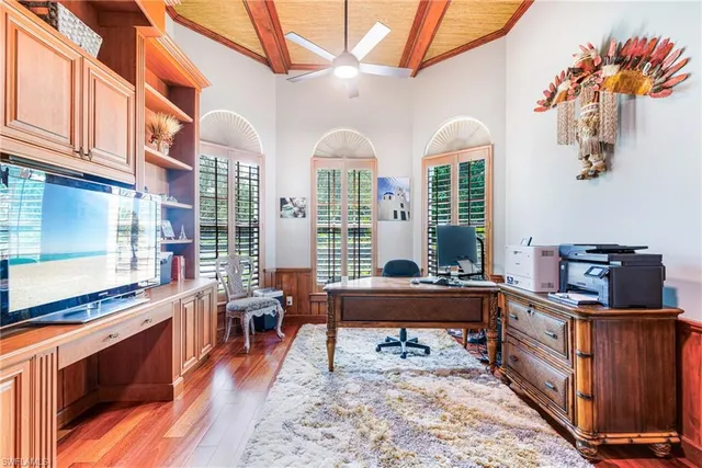a living room with stainless steel appliances granite countertop a stove and a wooden cabinets