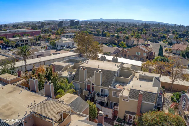 an empty room with closet and a chandelier fan