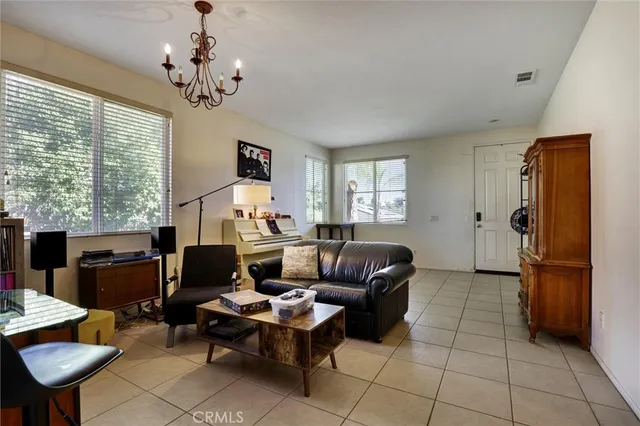 a living room with furniture a dining table and a window