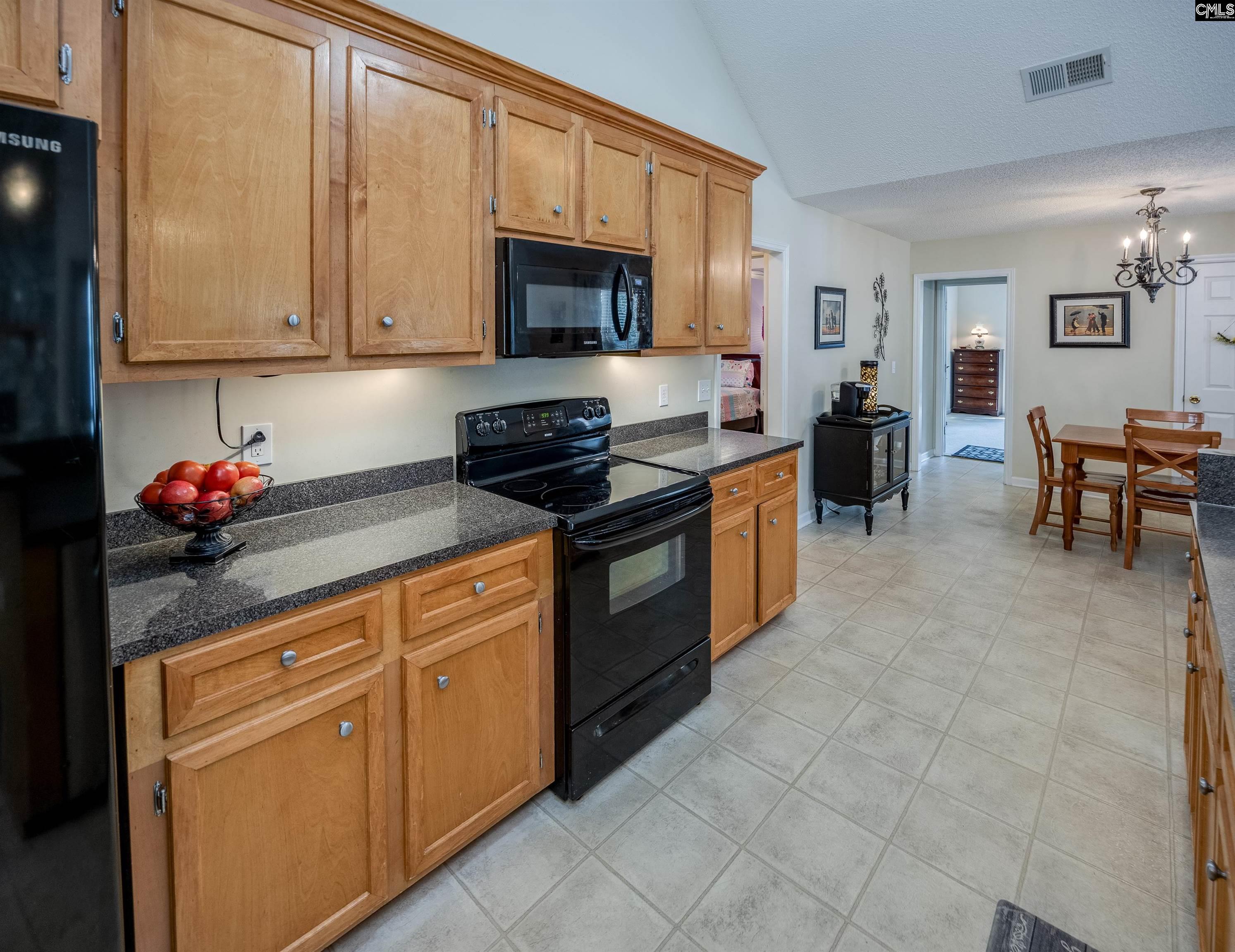 2032 Ridgeway Road Lugoff, SC 29078 - Photo 23 of 57 a kitchen with stainless steel appliances granite countertop a stove top oven a sink dishwasher and white cabinets
