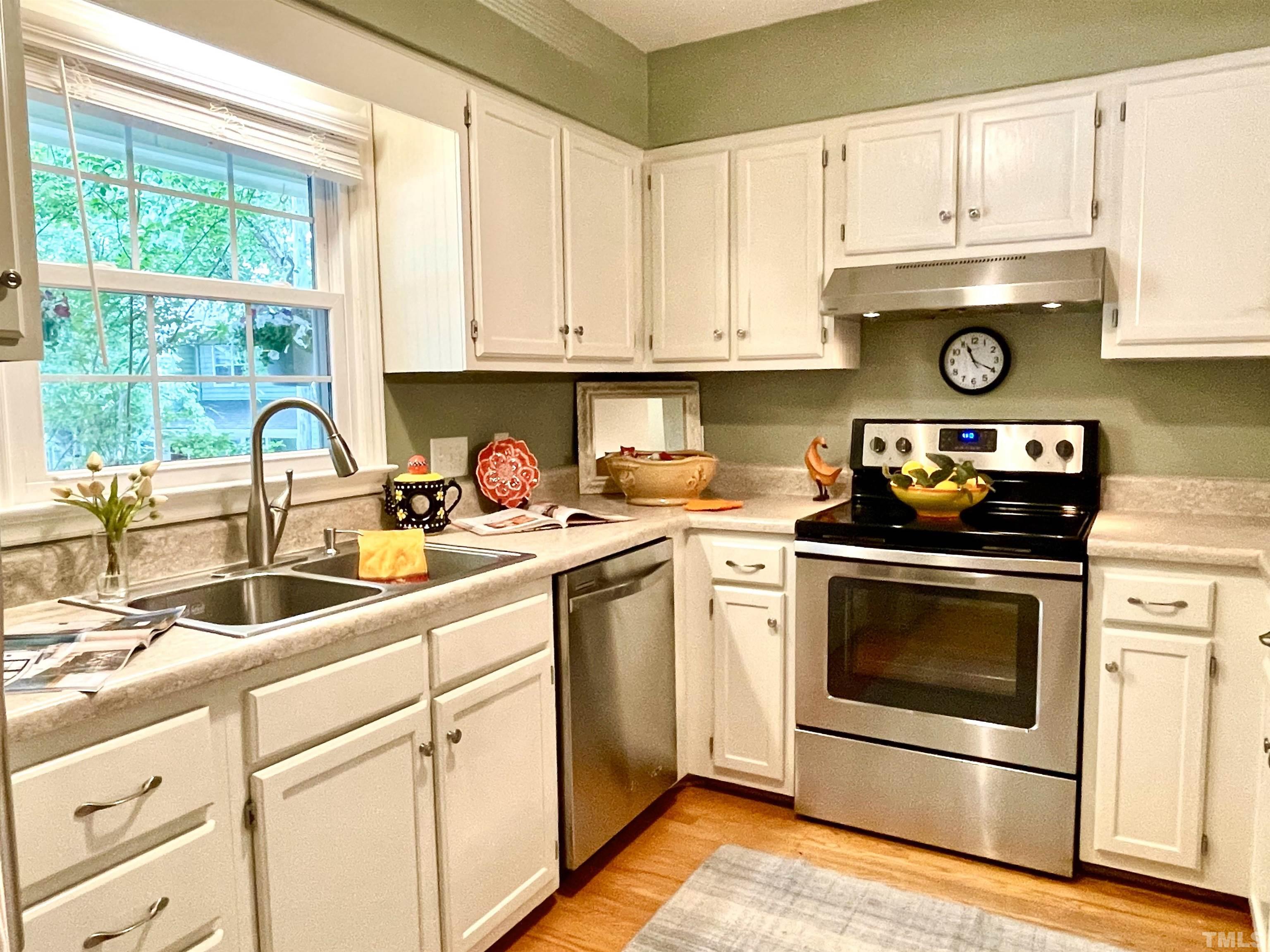 104 Long Shadow Place Durham, NC 27713 - Photo 3 of 11 a kitchen with stainless steel appliances granite countertop a sink stove and cabinets