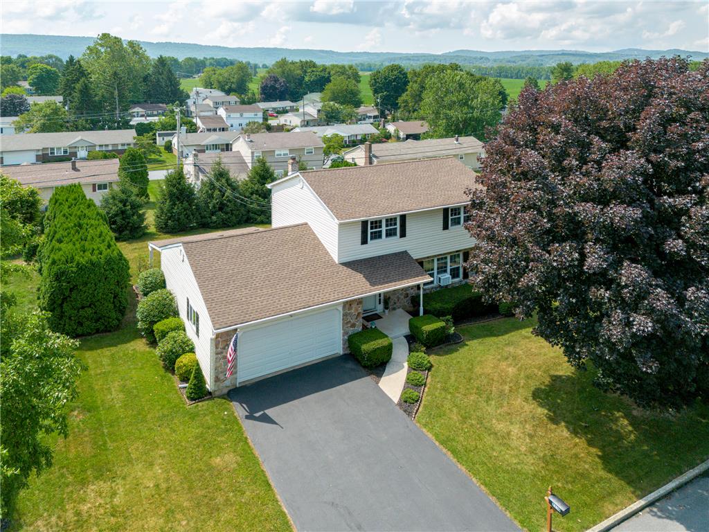 2130 Wisteria Road Lower Macungie Township, PA 18062 - Photo 3 of 48 An inviting exterior with a well-maintained driveway leads to a classic family home nestled in a serene neighborhood.