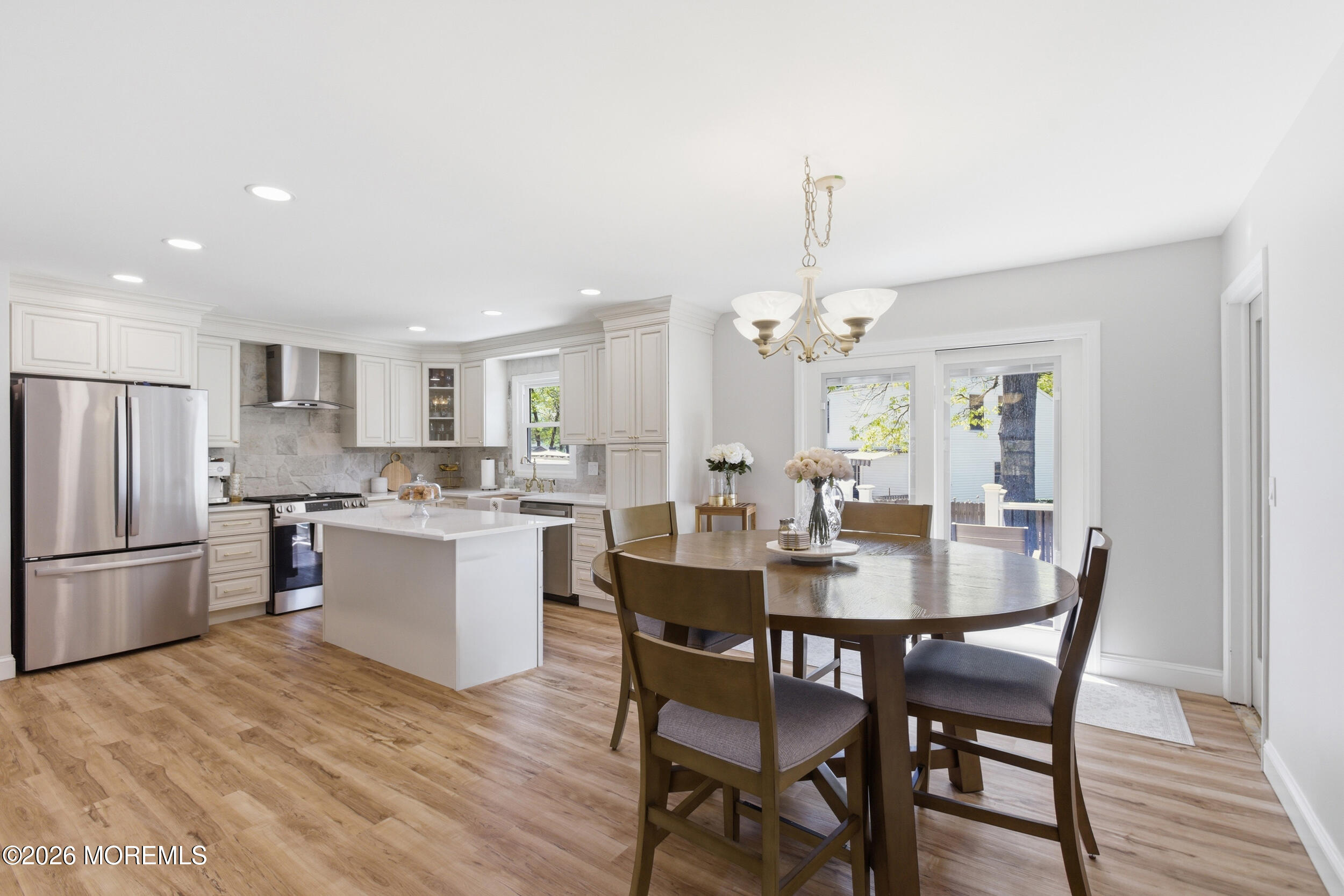 1635 Burrsville Road Brick, NJ 08724 - Photo 12 of 64 a dining room with a dining table chairs wooden floor and kitchen view