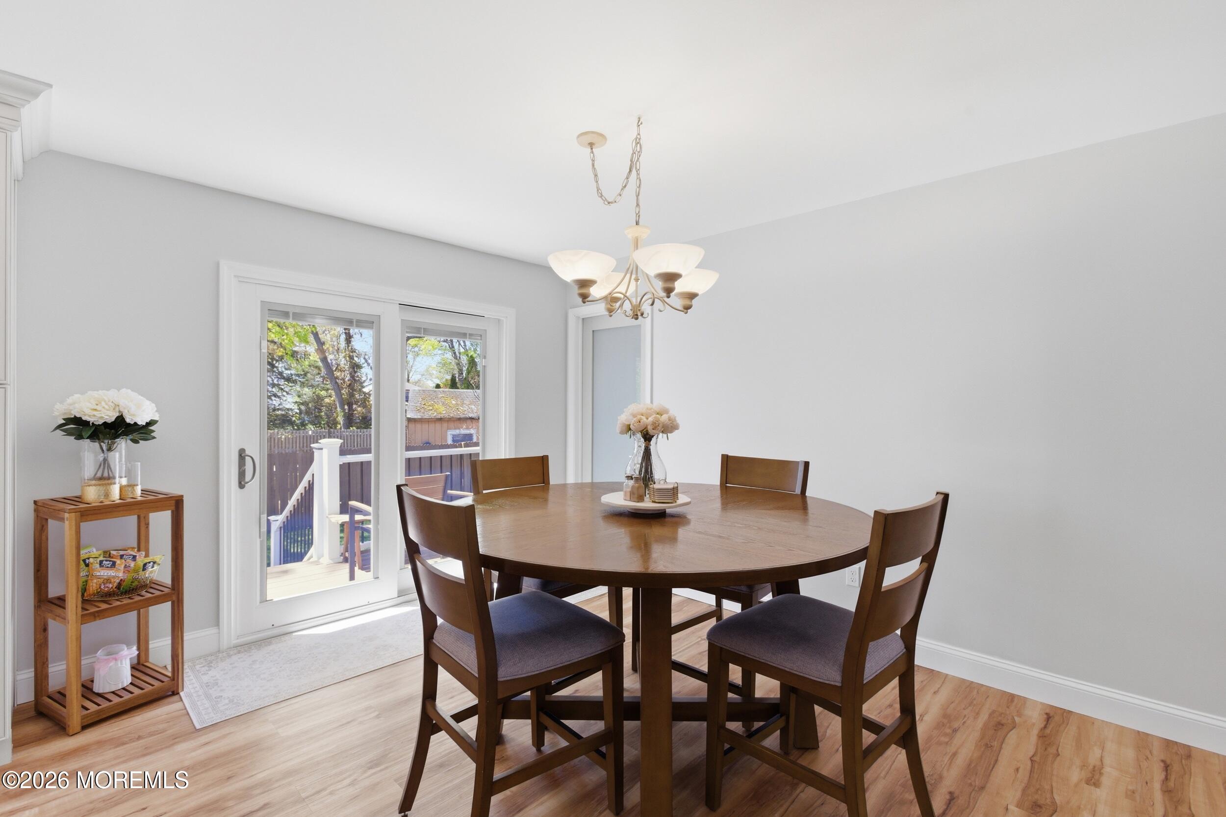 1635 Burrsville Road Brick, NJ 08724 - Photo 13 of 64 a dining room with furniture potted plants and wooden floor