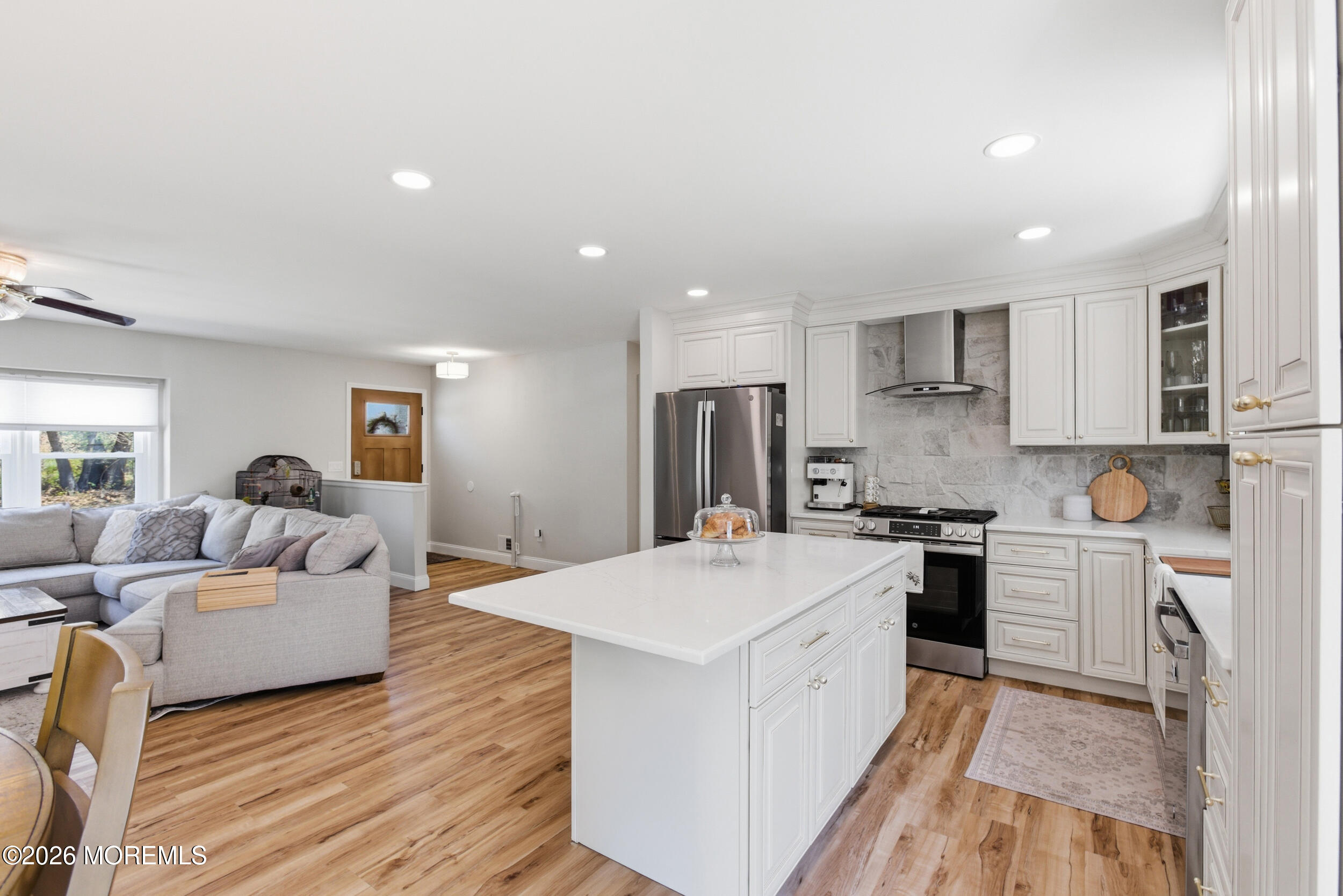 1635 Burrsville Road Brick, NJ 08724 - Photo 19 of 64 a large white kitchen with stainless steel appliances granite countertop a stove a sink a refrigerator and white cabinets with wooden floor