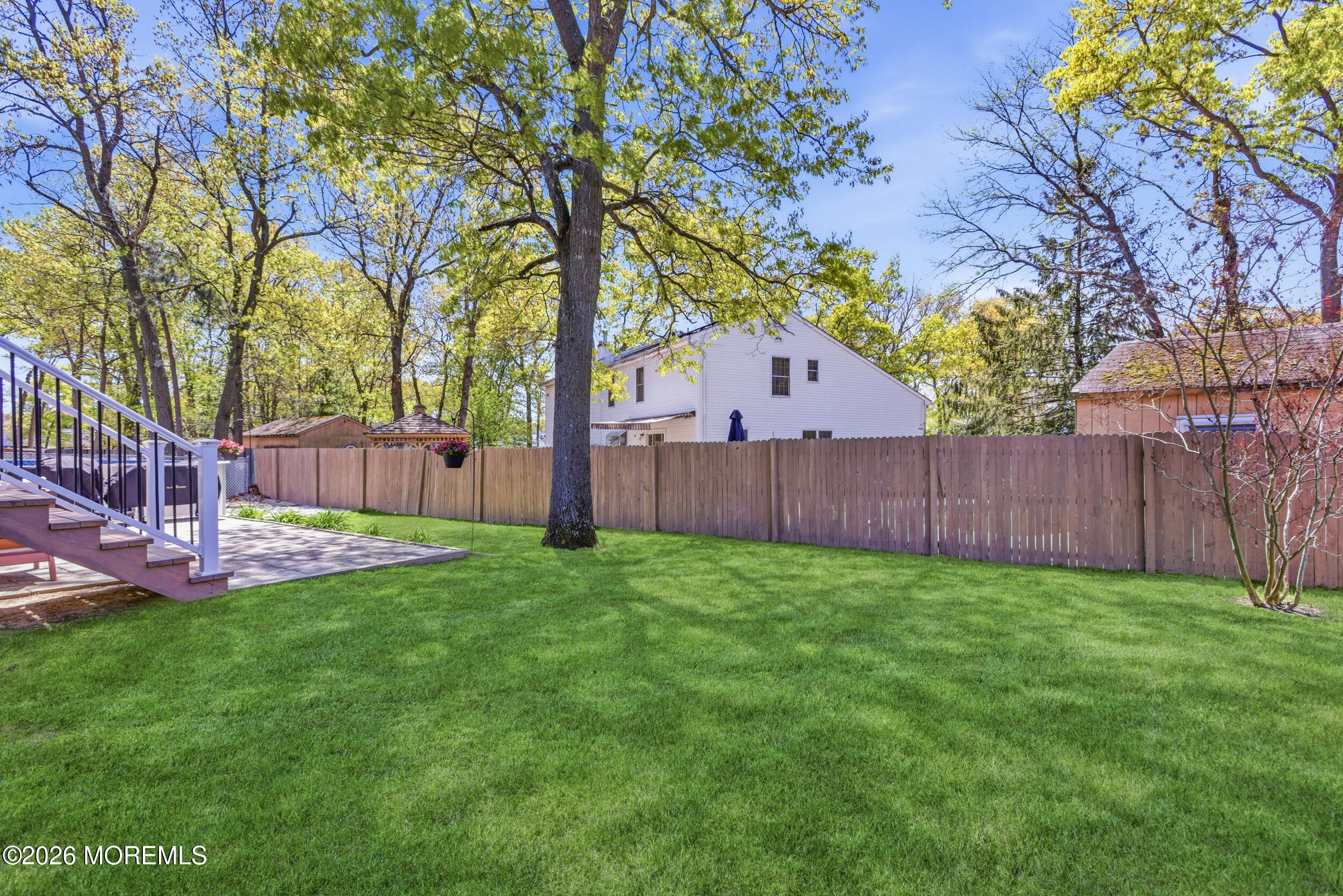 1635 Burrsville Road Brick, NJ 08724 - Photo 35 of 64 a view of a backyard with wooden fence and a large tree