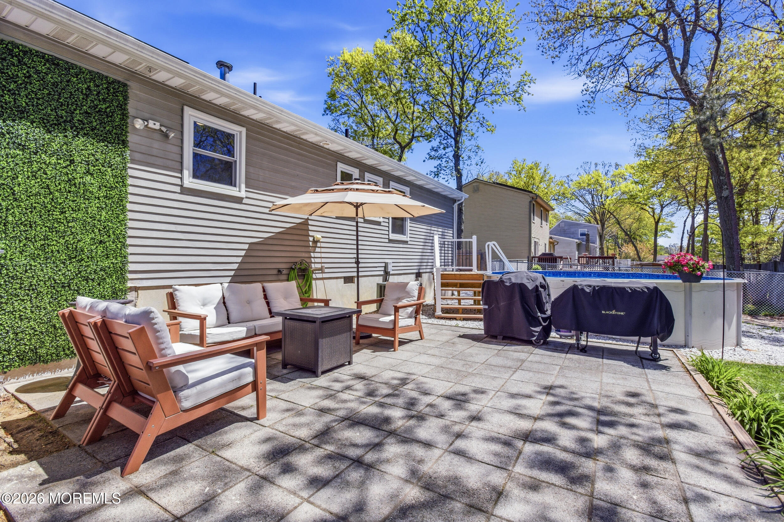 1635 Burrsville Road Brick, NJ 08724 - Photo 36 of 64 a view of a patio with a table and chairs under an umbrella