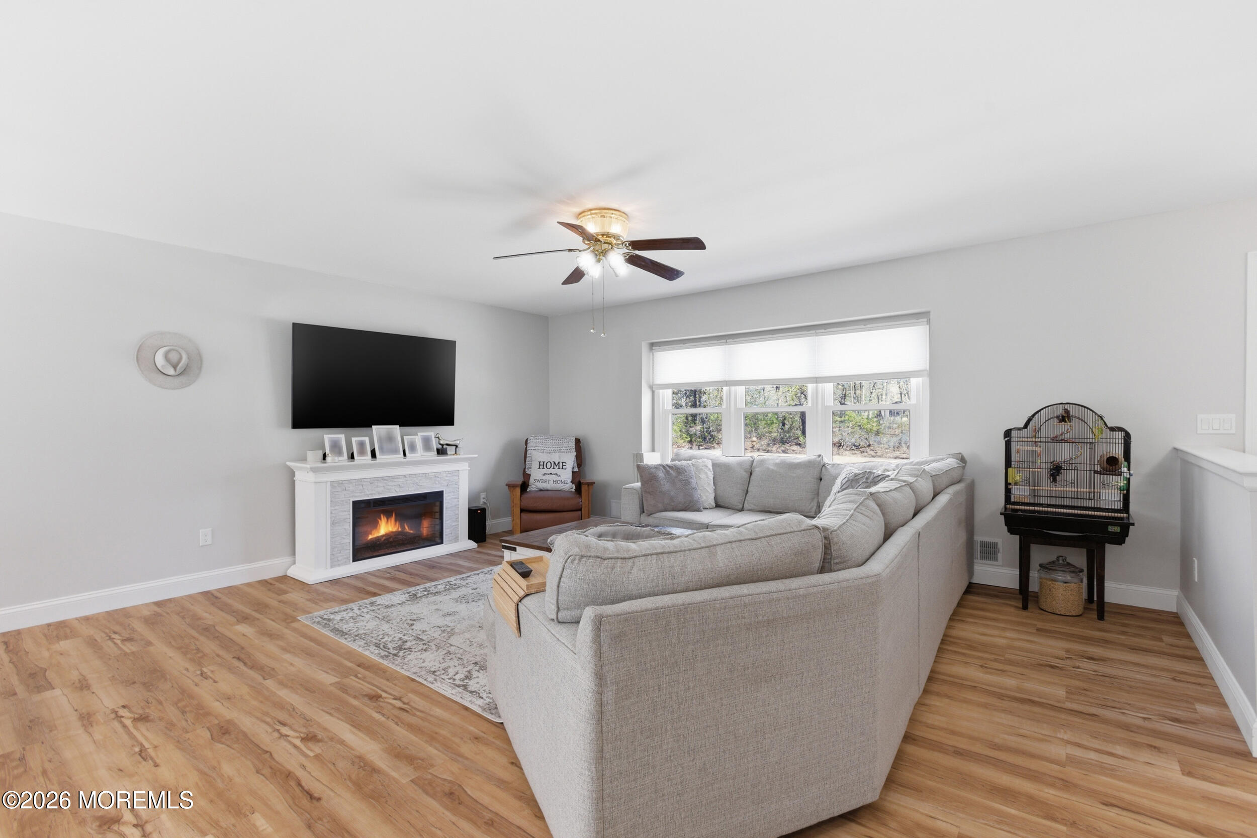 1635 Burrsville Road Brick, NJ 08724 - Photo 8 of 64 a living room with furniture a fireplace and a flat screen tv