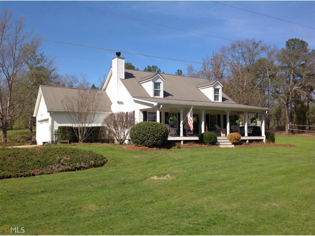 785 Handy Road Newnan, GA 30263 - Photo 1 of 1 a front view of a house with a garden and trees