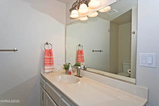 a bathroom with a sink vanity and a mirror