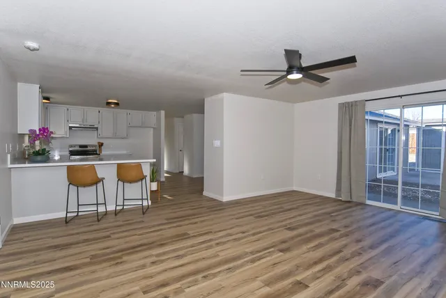 a kitchen with a table chairs refrigerator and cabinets