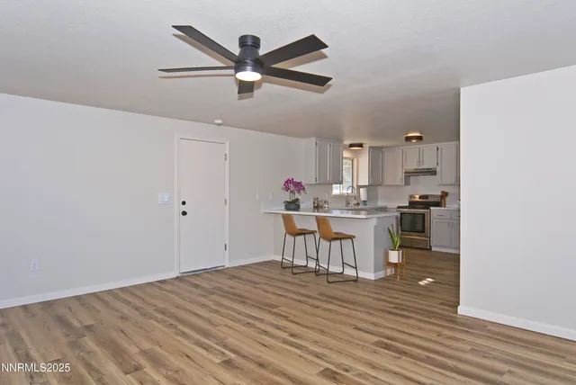 a kitchen with a refrigerator and white cabinets