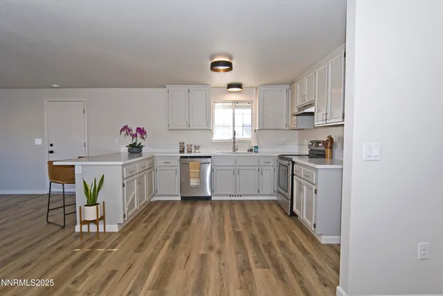 a kitchen with sink cabinets and wooden floor