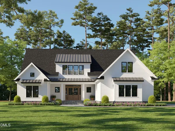 a front view of a house with a garden and trees