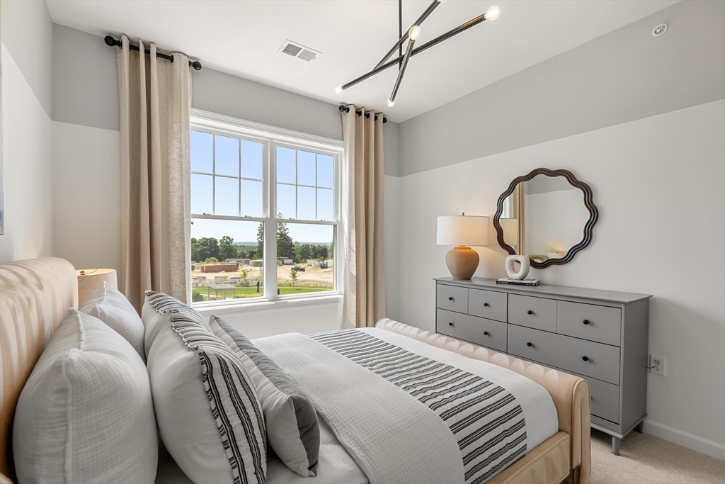 30 Coppersmith Way, Unit 409 Canton, MA 02021 - Photo 22 of 26 a bedroom with a large bed and a window
