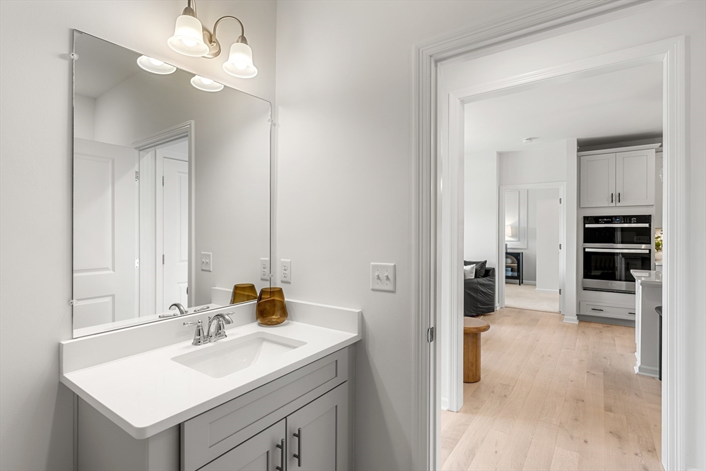 30 Coppersmith Way, Unit 409 Canton, MA 02021 - Photo 23 of 26 a bathroom with a sink a vanity and a mirror