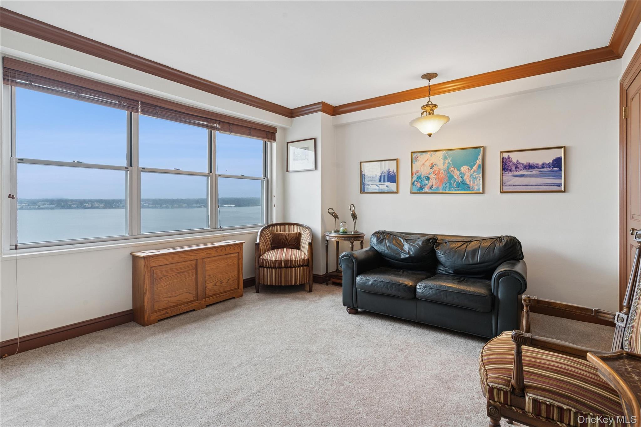 17-85 215th Street, Unit 15M Queens, NY 11360 - Photo 15 of 30 a living room with furniture and a window