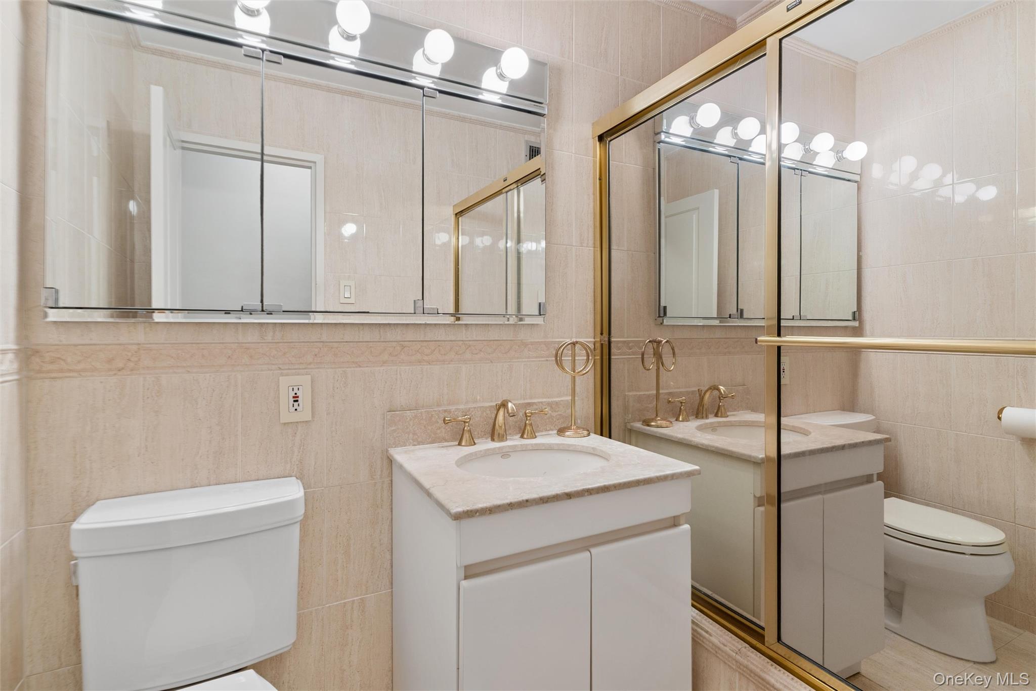 17-85 215th Street, Unit 15M Queens, NY 11360 - Photo 16 of 30 a bathroom with a toilet a sink and a mirror
