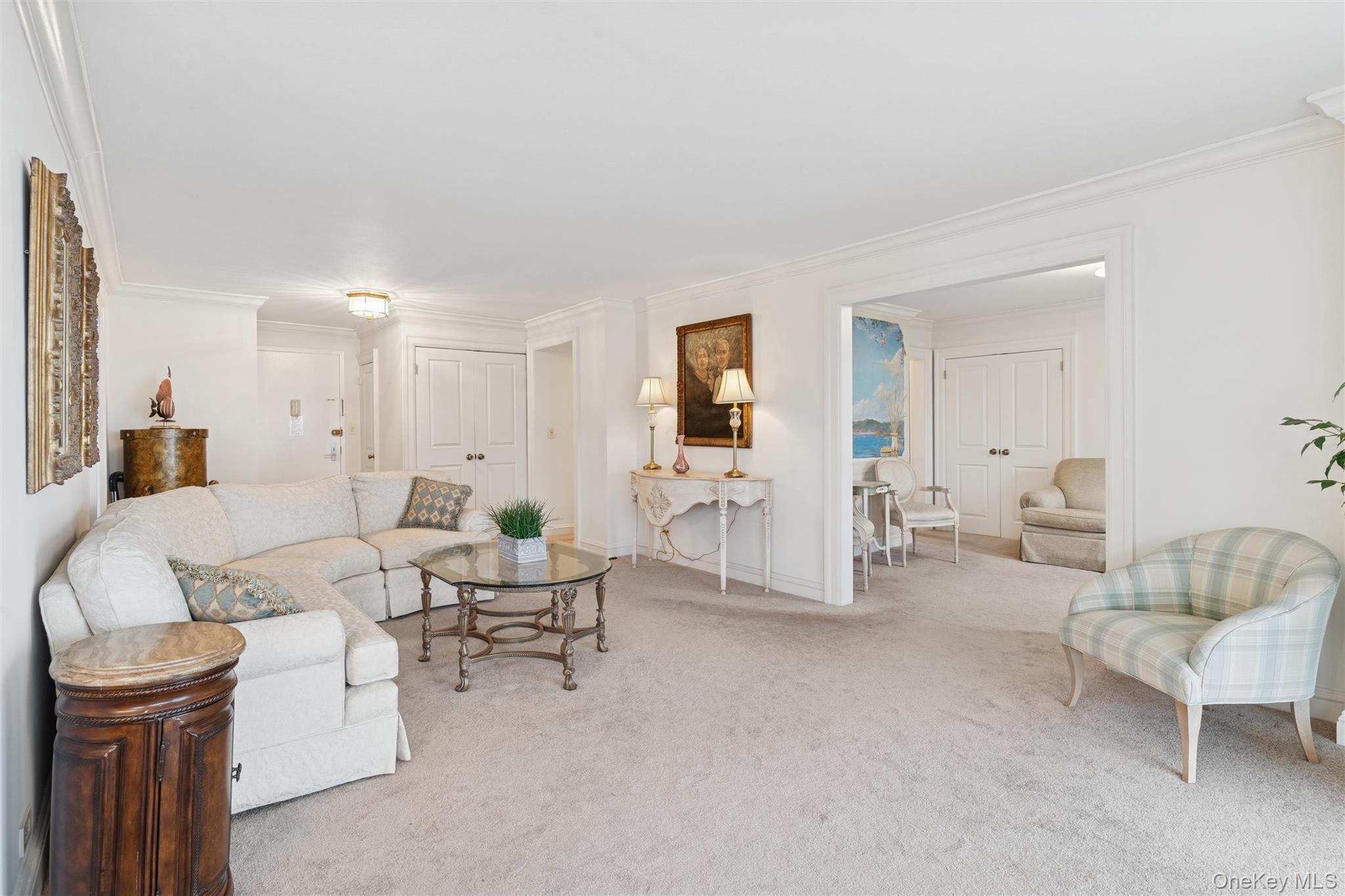 17-85 215th Street, Unit 15M Queens, NY 11360 - Photo 7 of 30 a living room with furniture and a table