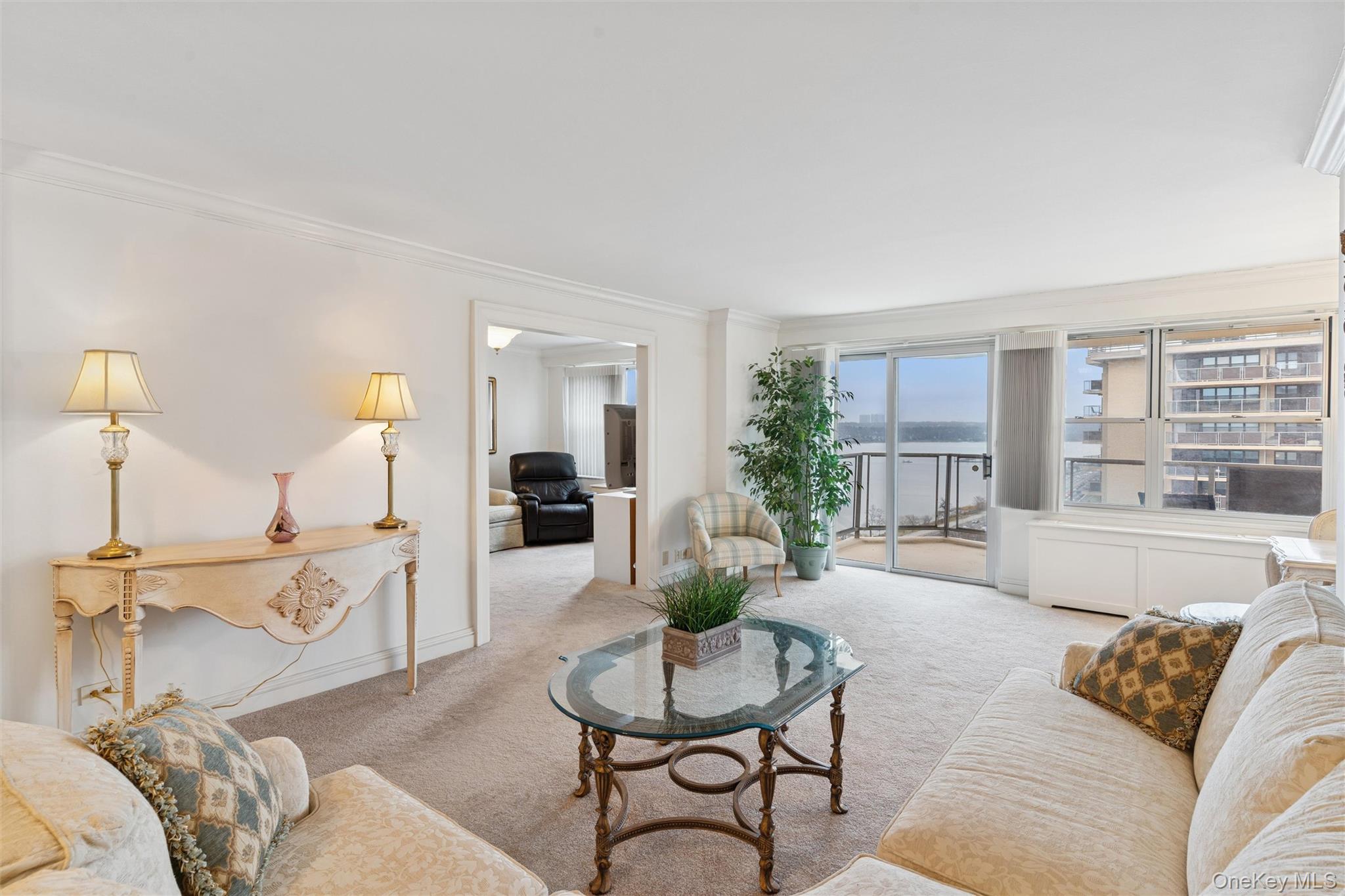 17-85 215th Street, Unit 15M Queens, NY 11360 - Photo 8 of 30 a living room with furniture and a table