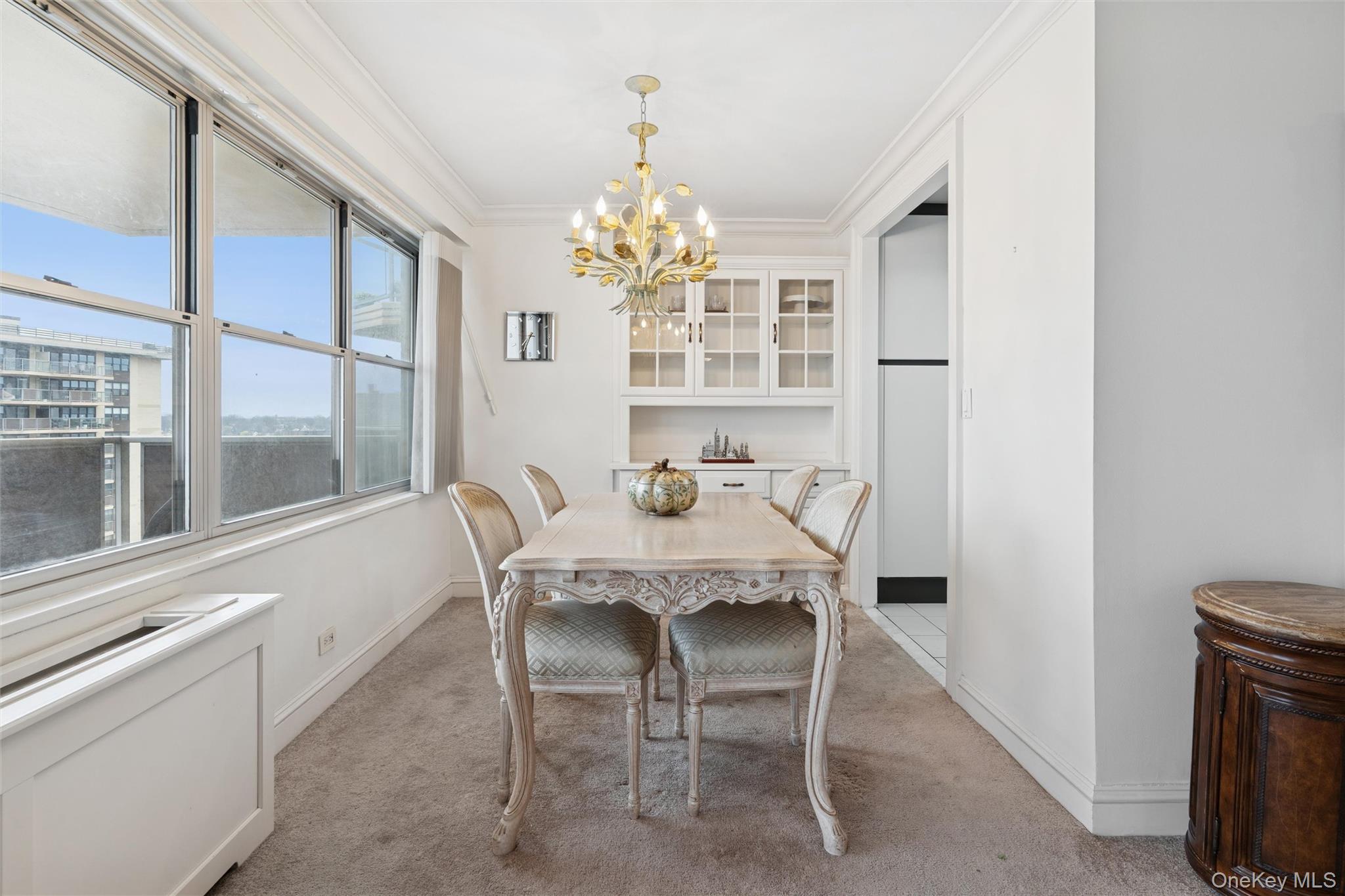 17-85 215th Street, Unit 15M Queens, NY 11360 - Photo 10 of 30 a view of a dining room with furniture large windows and wooden floor