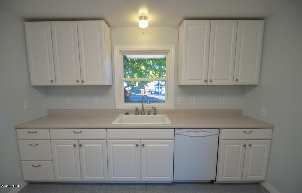 11703 Gilbert Road Yakima, WA 98903 - Photo 5 of 12 a kitchen with white cabinets