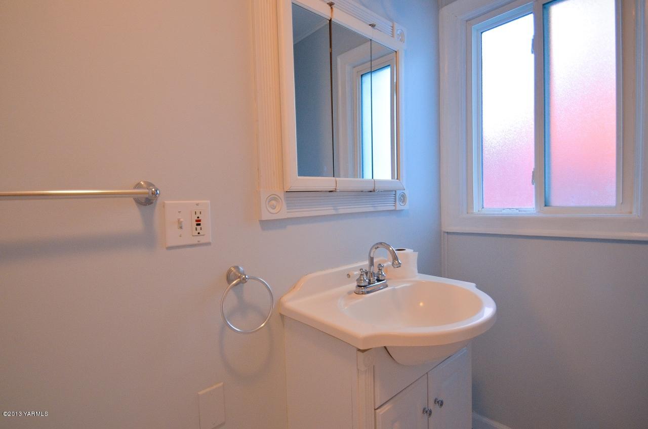 11703 Gilbert Road Yakima, WA 98903 - Photo 8 of 12 a bathroom with a sink and a window