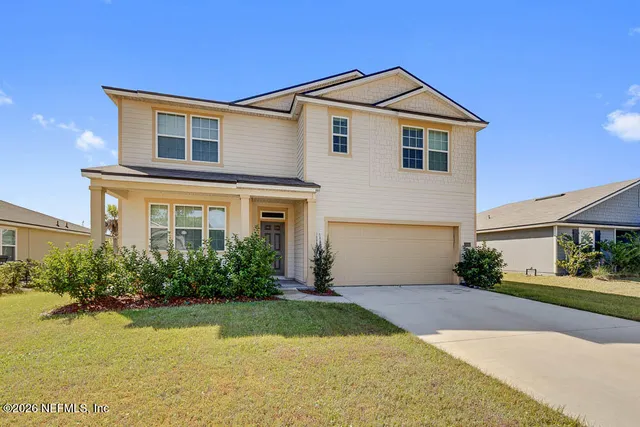 a front view of house with yard and green space
