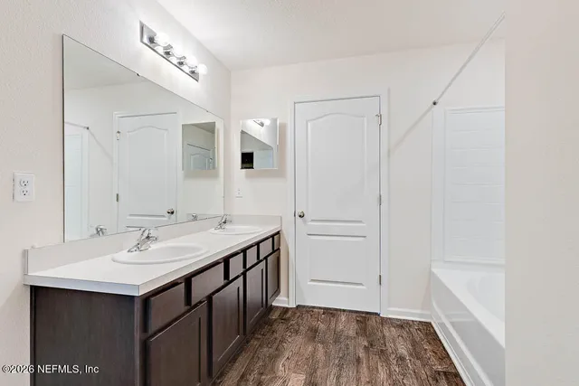 a bathroom with a sink and a mirror
