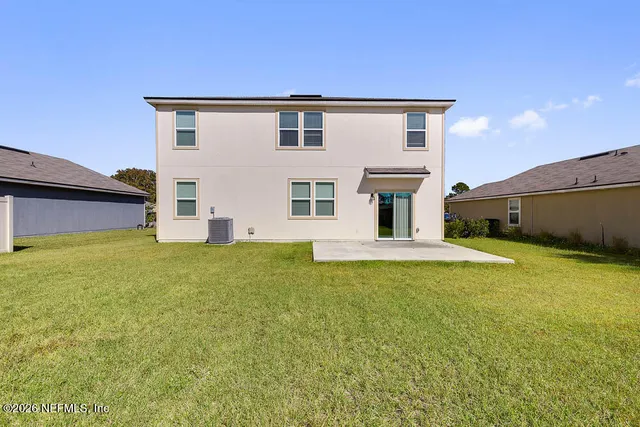 a sign board with a house and a street sign