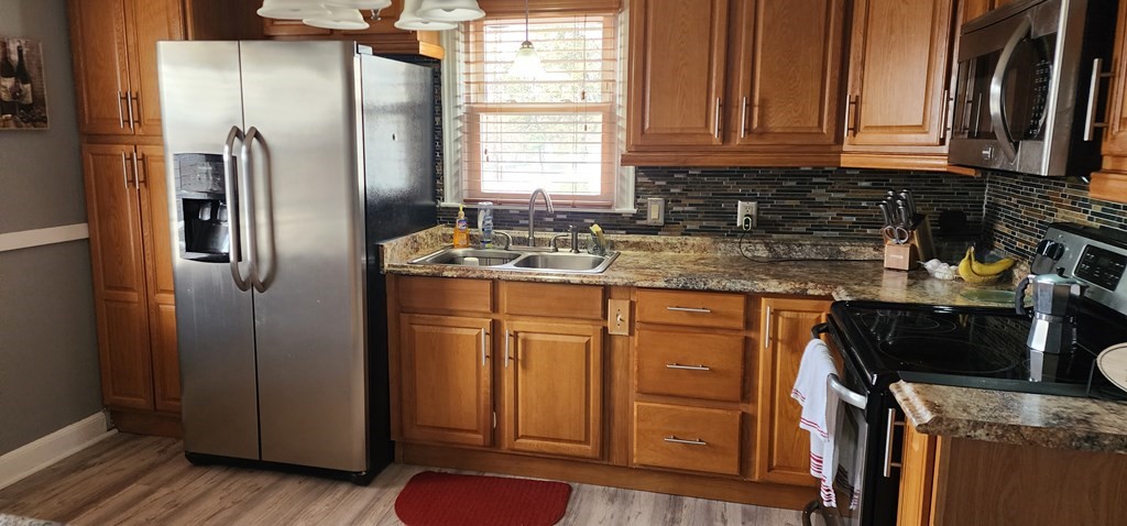 16 Abbott Street Springfield, MA 01118 - Photo 14 of 24 a kitchen with stainless steel appliances granite countertop a refrigerator sink and cabinets