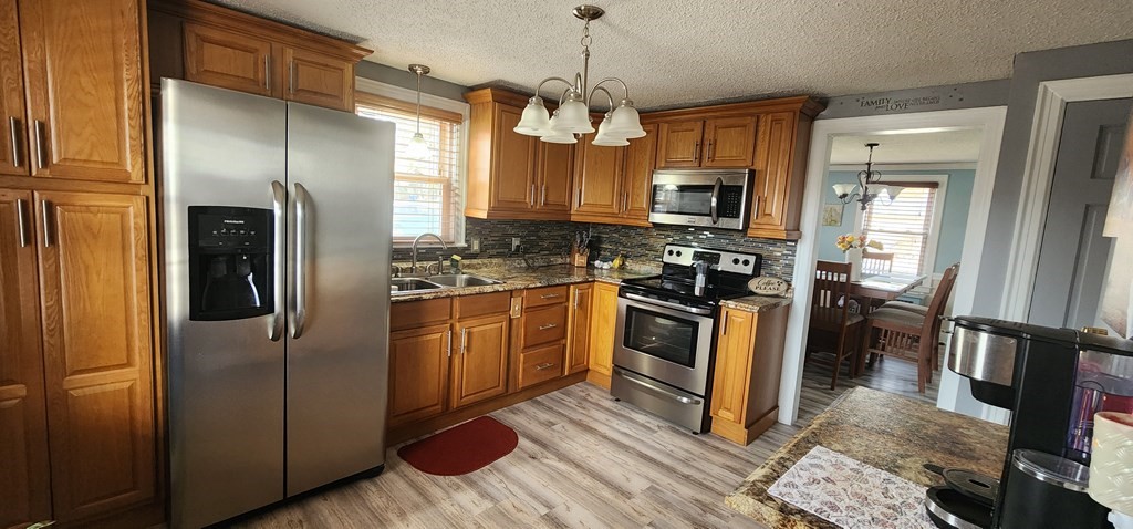 16 Abbott Street Springfield, MA 01118 - Photo 17 of 24 a kitchen with stainless steel appliances granite countertop a refrigerator a stove a sink and a microwave