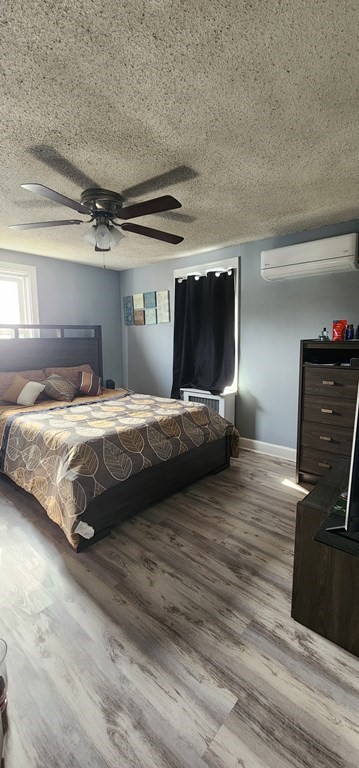 16 Abbott Street Springfield, MA 01118 - Photo 20 of 24 a bedroom with a bed and wooden floor