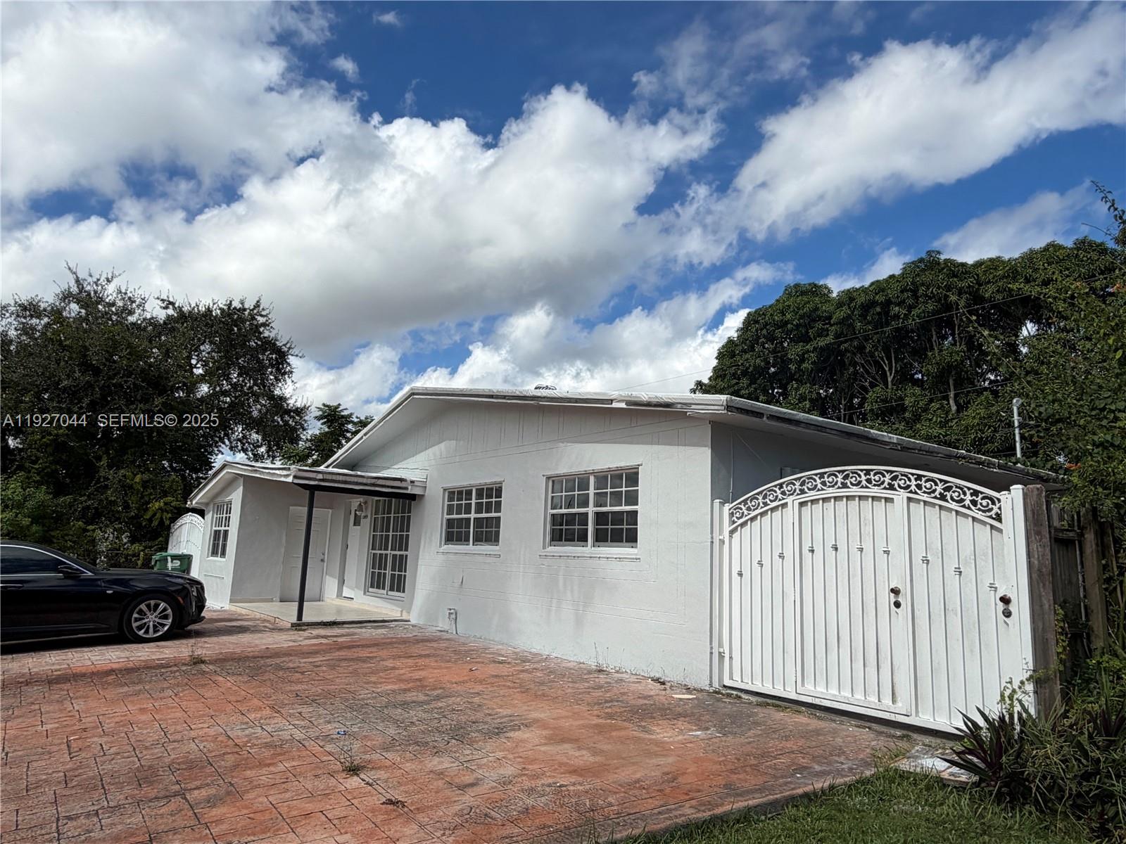 12455 Southwest 185th Terrace Miami, FL 33177 - Photo 1 of 18 front view of house with a yard