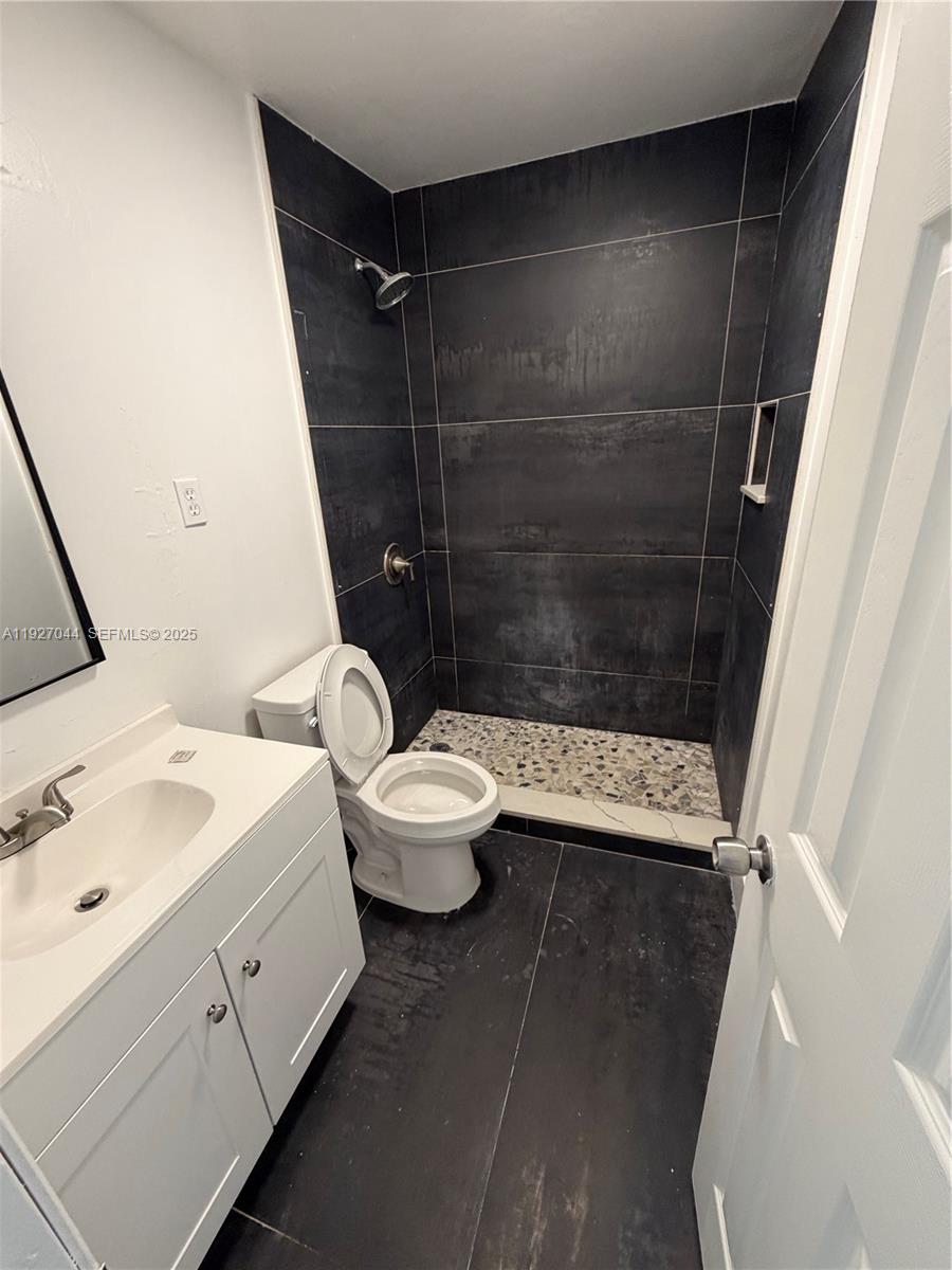 12455 Southwest 185th Terrace Miami, FL 33177 - Photo 13 of 18 a bathroom with a sink a toilet and shower