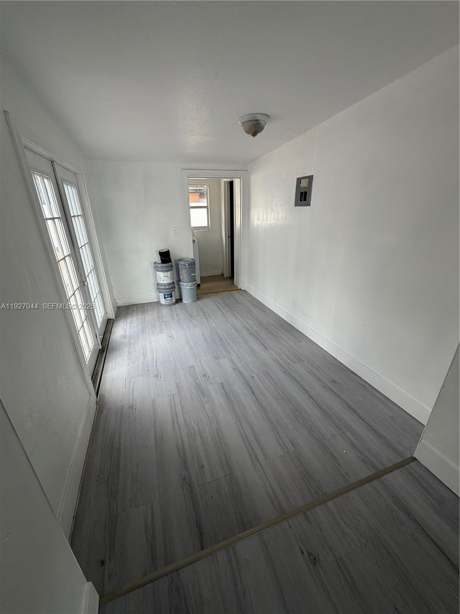 12455 Southwest 185th Terrace Miami, FL 33177 - Photo 4 of 18 wooden floor in an empty room with windows