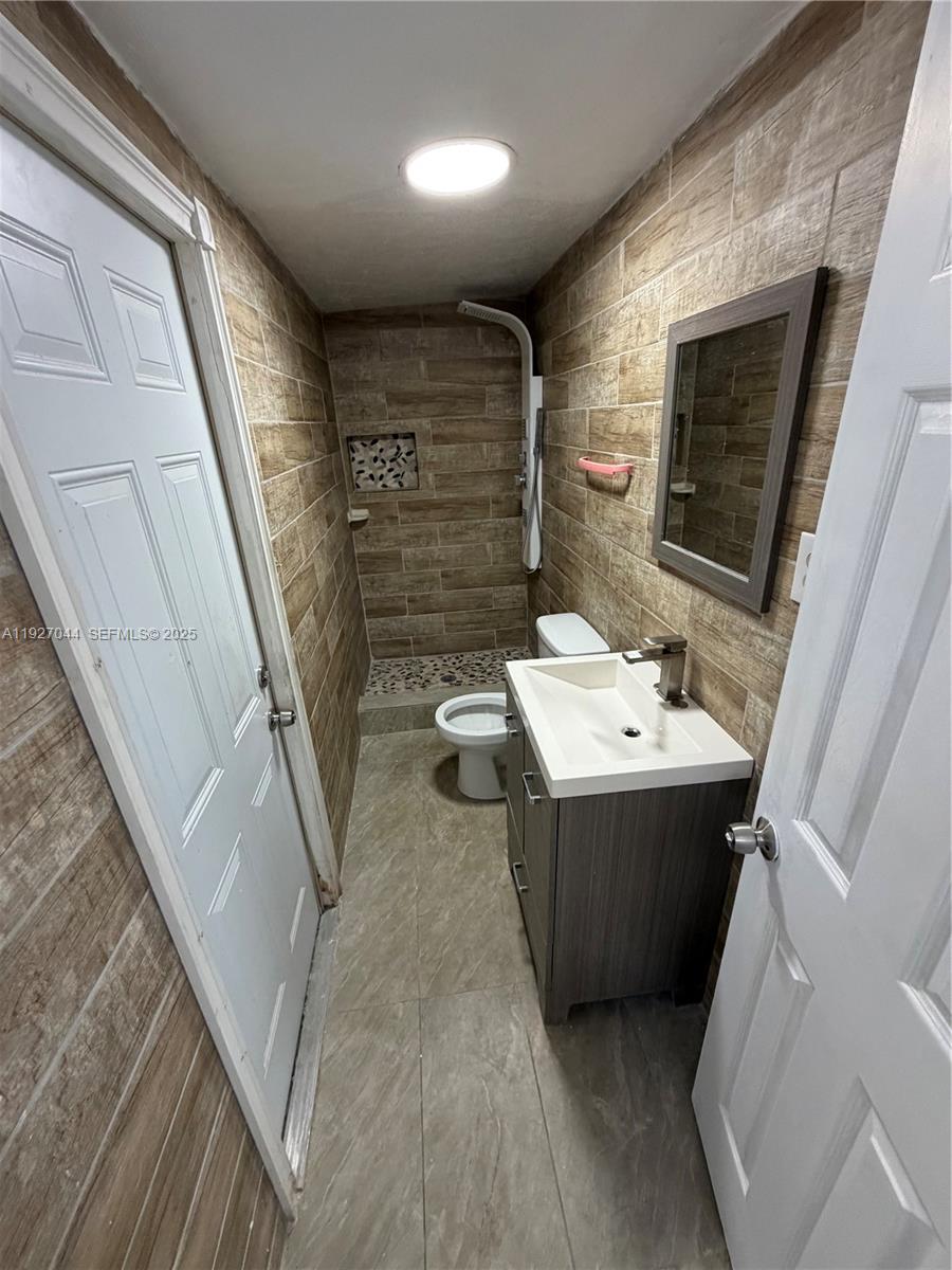 12455 Southwest 185th Terrace Miami, FL 33177 - Photo 7 of 18 a bathroom with a sink mirror and shower