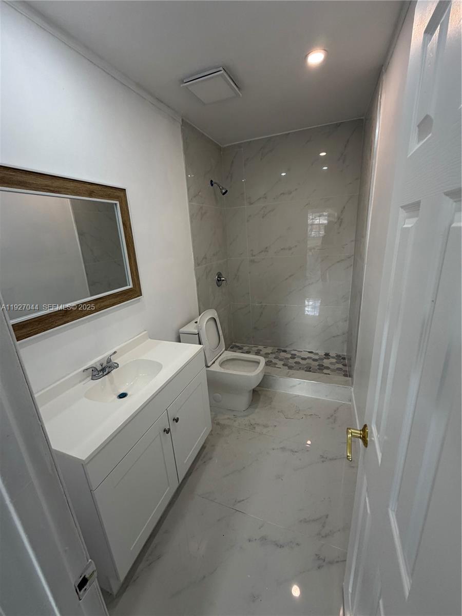 12455 Southwest 185th Terrace Miami, FL 33177 - Photo 8 of 18 a bathroom with a sink a toilet and shower