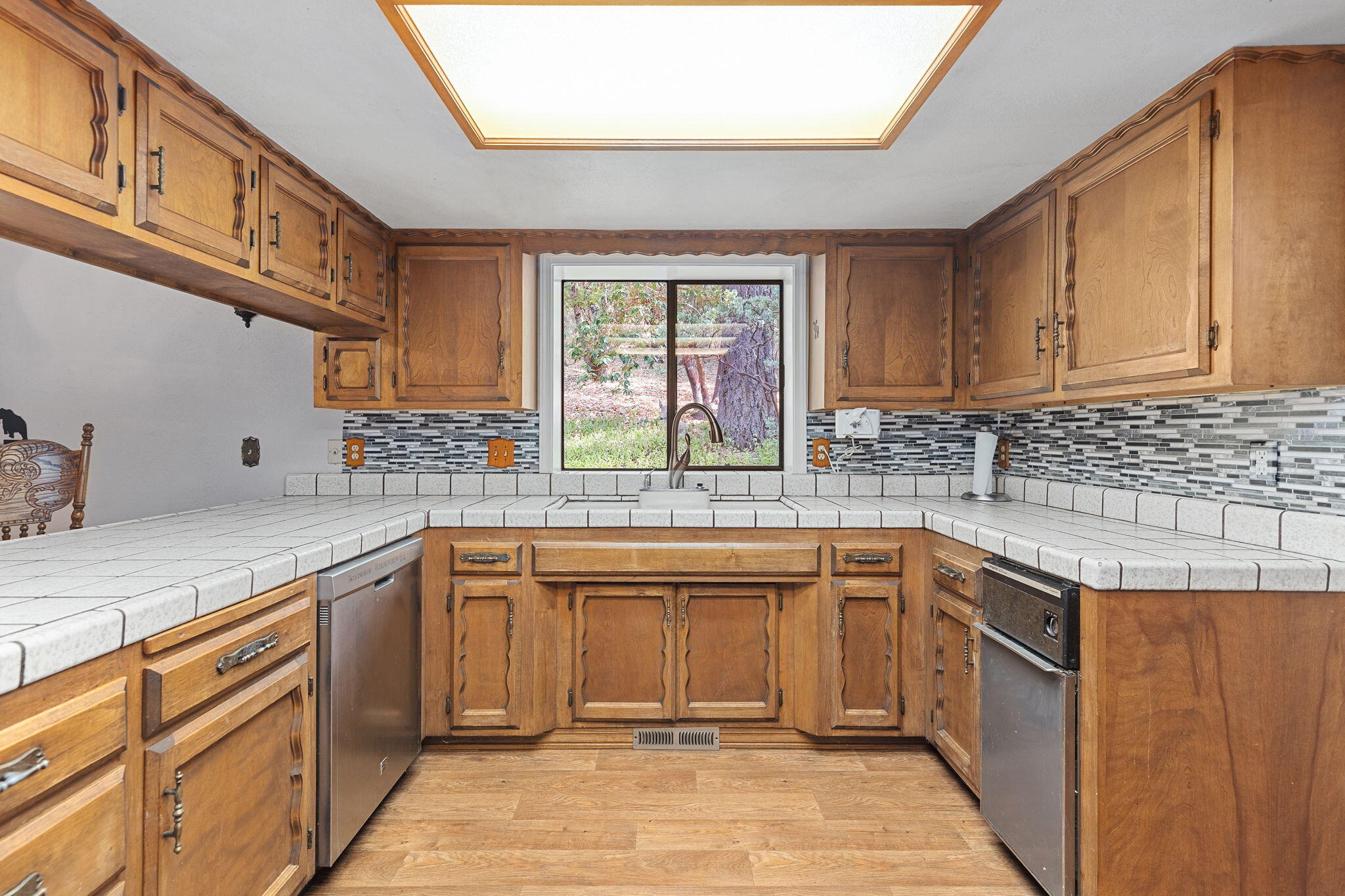 8860 Lower River Road Grants Pass, OR 97526 - Photo 7 of 48 a kitchen with stainless steel appliances granite countertop a sink stove and cabinets