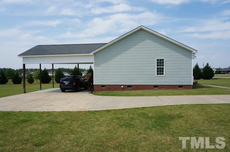 6972 Rock Ridge Sims Road Sims, NC 27880 - Photo 19 of 21 Driveway side of this home offers a large -car attached carport that leads into the back Mud room/ laundry area.
